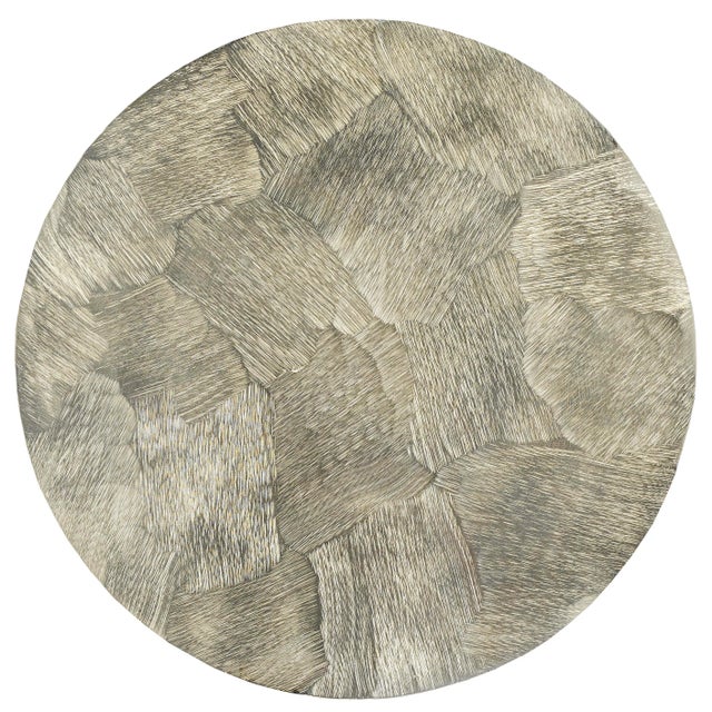 The shape of the Talia Champagne Accent Table is a riff on turned wood candle-sticks, but this silver accent table is made...