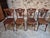 Set of four antique French bistro chairs by Thonet, dating from circa 1920. Crafted from beech wood, the chairs feature...