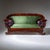 Biedermeier sofa with a shaped apron and rolled legs. The armrests are decorated with stylized cornucopias, while delicate...