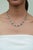 This elegant necklace features 5.71 carats of oval-cut emeralds Crafted in 14K white gold, measuring approximately 6 x 4...