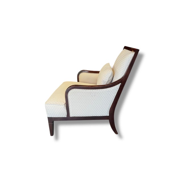 This elegant accent chair features a beautifully shaped solid wood frame paired with soft, neutral upholstery detailed in...