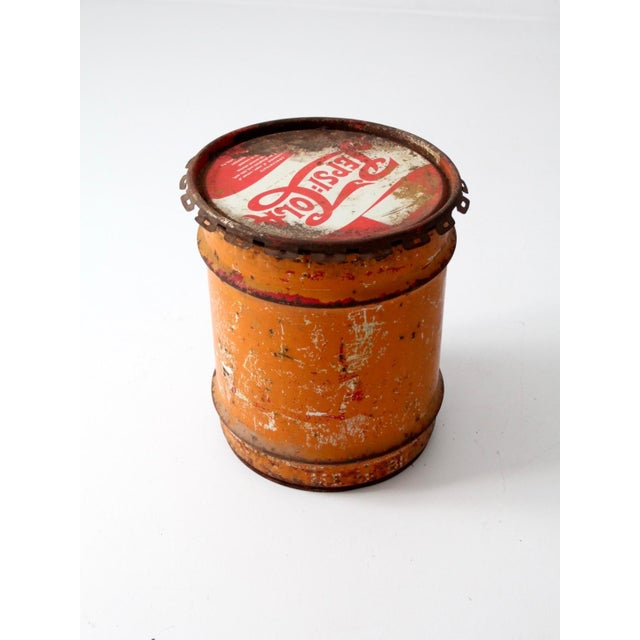 This well-worn vintage 1940s Pepsi-Cola concentrate can is a rare piece of soda history. The 10-gallon metal drum has...