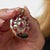 This elegant Mid Century ruby and diamond pendant is a beautifully dramatic jewel from the 1950’s, featuring 9 oval cut...