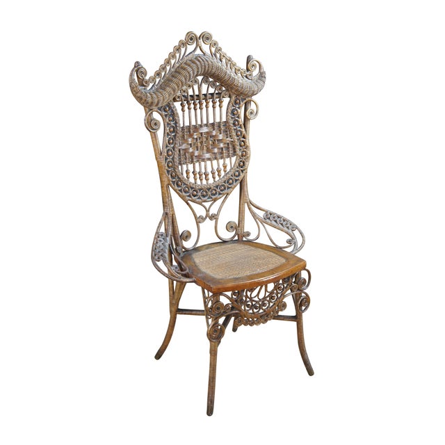 Antique Victorian portrait chair by the Indianapolis manufacturing company. Made of wicker and rattan featuring serpentine...