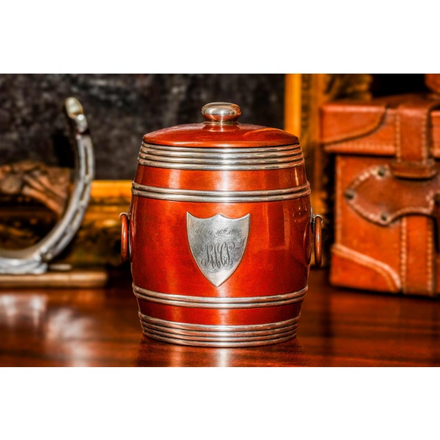 This American Arts and Crafts style humidor features an elegant barrel-shaped design with sterling silver accents and...