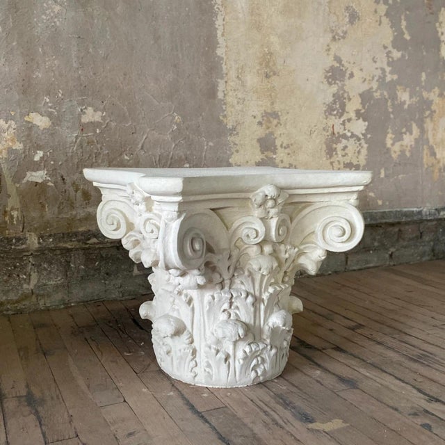 Handmade Corinthian Capital side table made of white painted plaster with touches of grey on the sides. It's a striking...