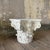 Handmade Corinthian Capital side table made of white painted plaster with touches of grey on the sides. It's a striking...