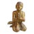 A lacquered and gilded Buddhist monk in a traditional pose with hands together and a serene facial expression. Gilt over...