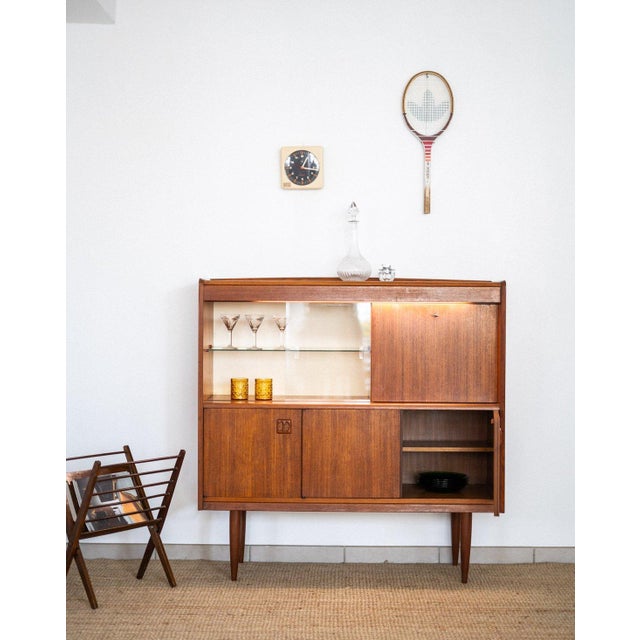 A 1960s teak veneer display cabinet/bar buffet with a design strongly inspired by the Scandinavian lines of the period....