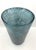 Oval-shaped vase in aquamarine glass with an all-over metallic decoration. The designer is Toni Zuccheri, who began...