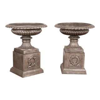 Pair, Mid 20th Century Cast Iron Planting Urns Resting on Square Plinth For Sale