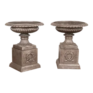 Pair, Mid 20th Century Cast Iron Planting Urns Resting on Square Plinth