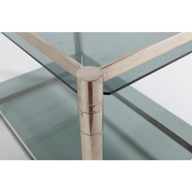 Beautiful Italian modern design chromed steel serving trolley/side table on wheels from 1970’s. Fitted with 2 tinted glass...