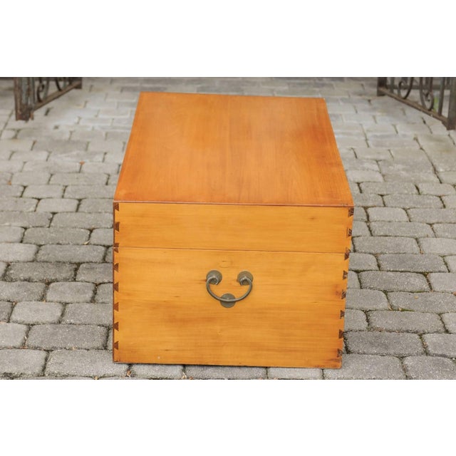 An Asian camphor wood box from the early 20th century, with traditional lockset on medallion and lateral handles. This...
