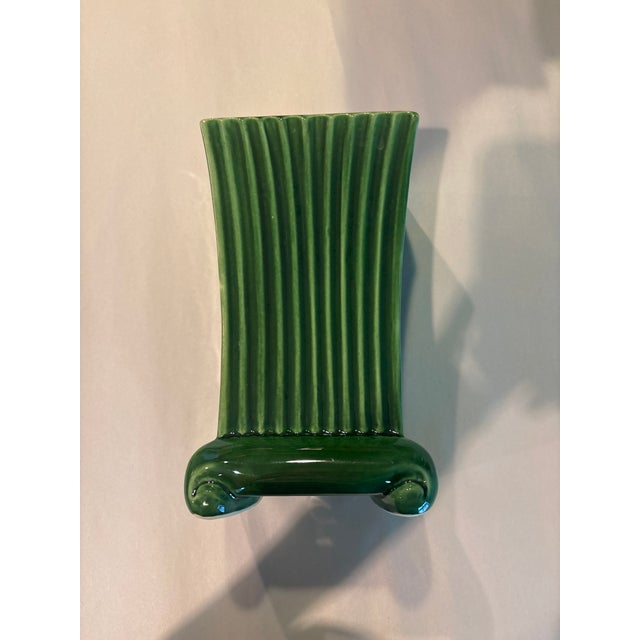 Elegant pair of vintage ceramic cachepots featuring a strong vertical ribbed form and classic pedestal bases. Finished in...