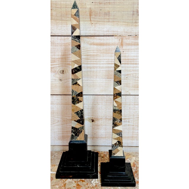 A striking pair of graduating tessellated specimen marble obelisks by Maitland-Smith, executed in the late 20th century...