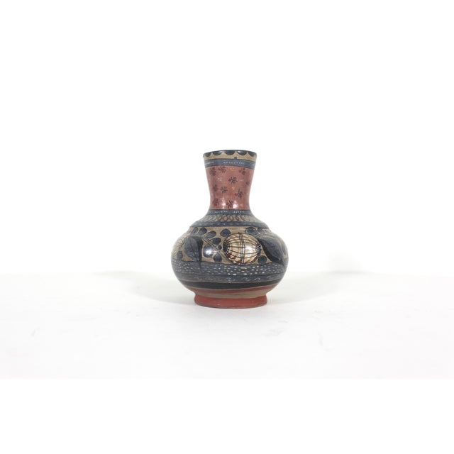 This is a charming vintage burnished clay bud vase, handmade and hand painted in Mexico. It is signed by the artist. It is...