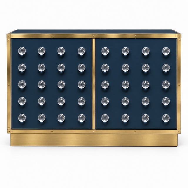 Made to order in Italy, this sculptural dry bar is offered in a deep navy finish with a low, continuous brass plinth in...