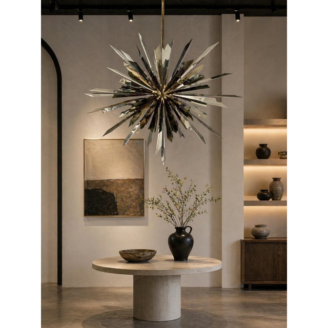 Dramatic and sculptural California "Sunburst" chandelier by Remains Lighting, crafted in solid brass with contrasting...