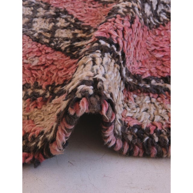 This vintage Moroccan rug from the Middle Atlas Mountains features a symbolic grid of large diamond shapes filled with...