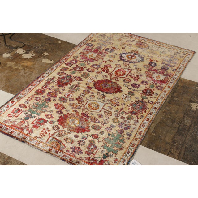 Handknotted in a fine blend of wool and silk, this 5x9 modern rug draws inspiration from traditional Agra...