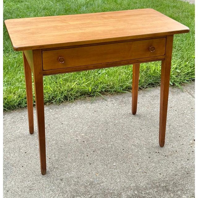 Beautiful maple writing desk with tapered legs and a drawer with wooden knobs. Midcentury Americana in the style of Ethan...