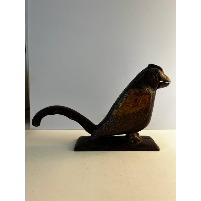 Marvelous antique cast iron painted bird nutcracker. Tail lifts to receive nut in mouth. Opens to 1-1/8 inches. Great...