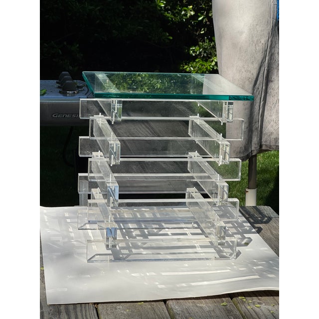 This Stacked Lucite Side End Table with Glass Top is a sleek and modern addition to any living room. The clear glass...