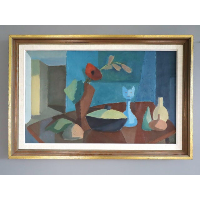 STILL LIFE WITH CAT FIGURINE Size: 17.1 x 25.4 inches (including frame) Oil on board A charming mid-century modernist...