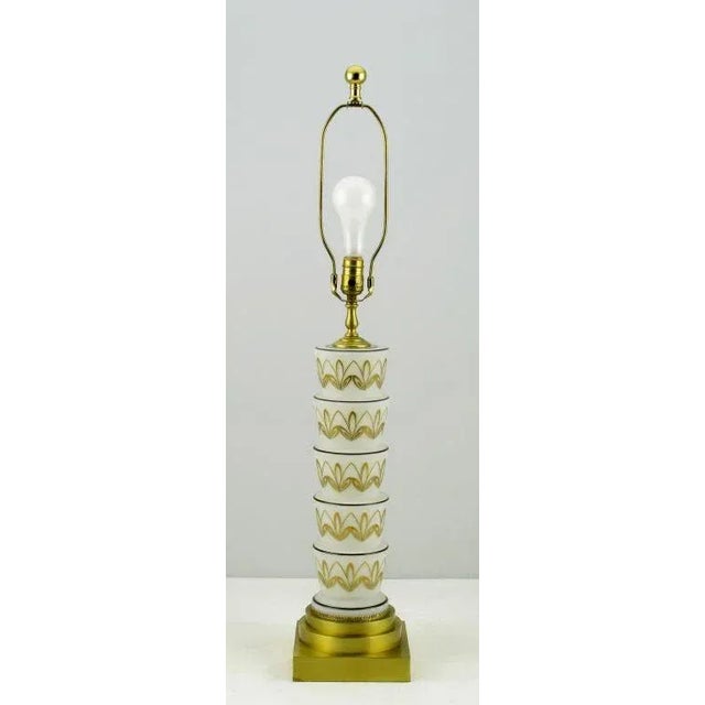 Elegant stepped white glass with hand painted gold and black design on this art deco style table lamp. The base is a...