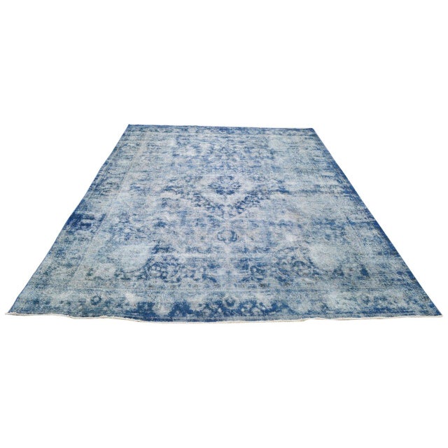 Hand-knotted with care using traditional rug-making techniques, this vintage wool rug blends timeless craftsmanship with a...