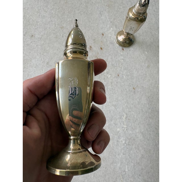 Antique sterling silver salt and pepper shakers featuring a monogrammed. Possibly letter B.