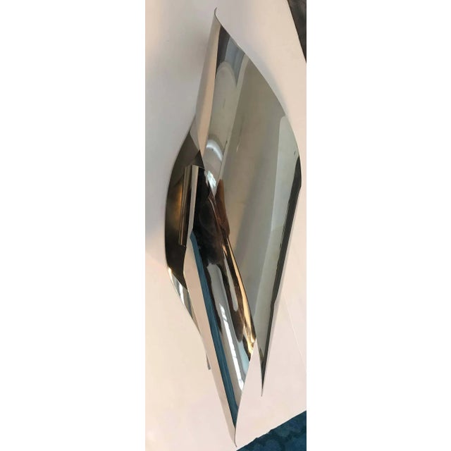 A beautiful and sleek modern French 1970s large sculptural hand crafted wall light by famed French bronze artisans,...