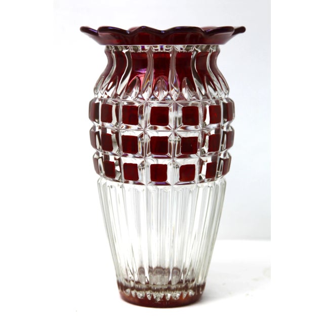 Vibrant, Cranberry collard cased-crystal glass vase in the Bohemian style with cut-to-clear geometric decoration. The body...