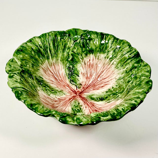 This is a stunning Cabbagewear Serving Bowl. The piece has a Majolica finish and deep green coloring wth Trompe L’Oeil...