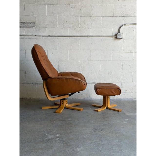Comfortable and sculptural Danish Modern reclining lounge chair with matching ottoman, crafted in Denmark during the...