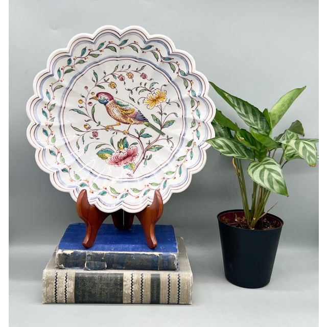A vintage hand-painted Portuguese ceramic bowl featuring a colorful bird of paradise among flowering branches. Marked...