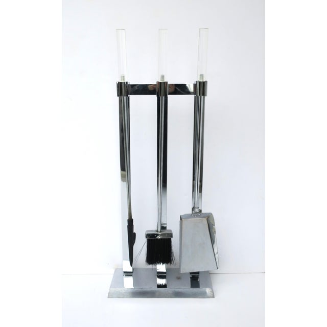 A metal chrome and Lucite fireplace tool set, in the Modern style, attributed to designer Alessandro Albrizzi, circa...