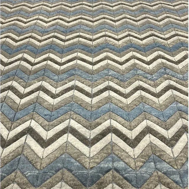 Moroccan style area rug featuring a modern all-over design in a blue and gray color palette. Hand-woven from an extra...