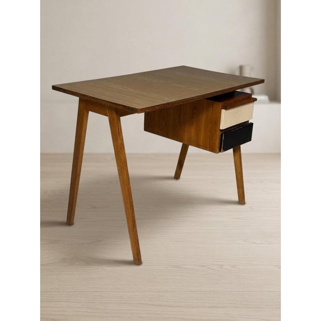 A distinctive mid-century writing desk designed by British designer Robin Day in the 1950s. Robin Day developed an...