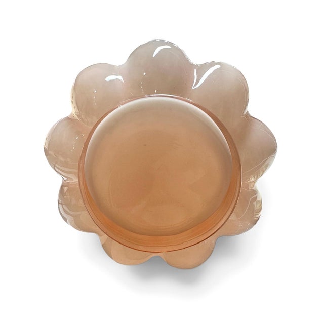 A striking vintage art glass vase in a beautiful soft blush-pink hue, featuring a sculptural ribbed body and an exuberant...