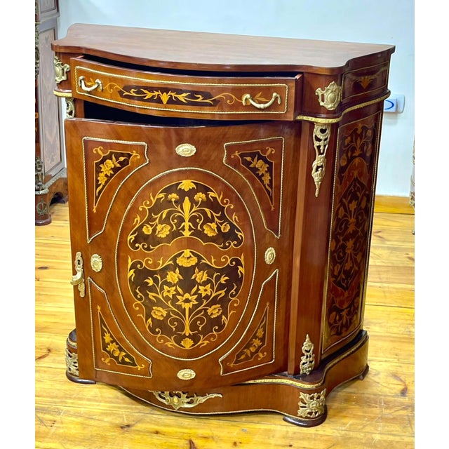 Elevate your interior with this stunning French-style marquetry cabinet, masterfully crafted with intricate floral inlay...