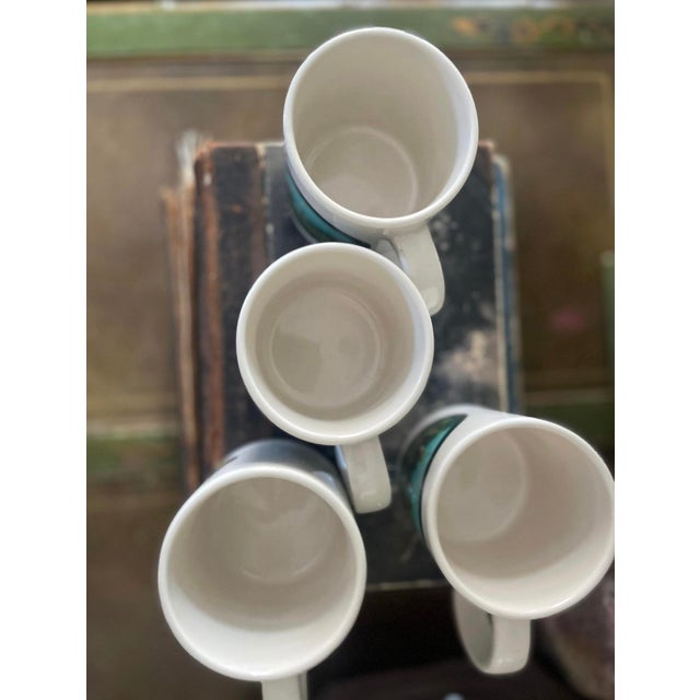 Fantastic set of four coffee mugs, the set is by Ralph Lauren. Presented in a crisp white, it depicts a scene on the front...
