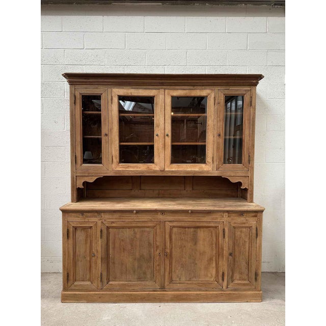 This antique solid oak country-style cabinet has been fully restored. The upper section features four lockable glass-...