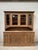 This antique solid oak country-style cabinet has been fully restored. The upper section features four lockable glass-...