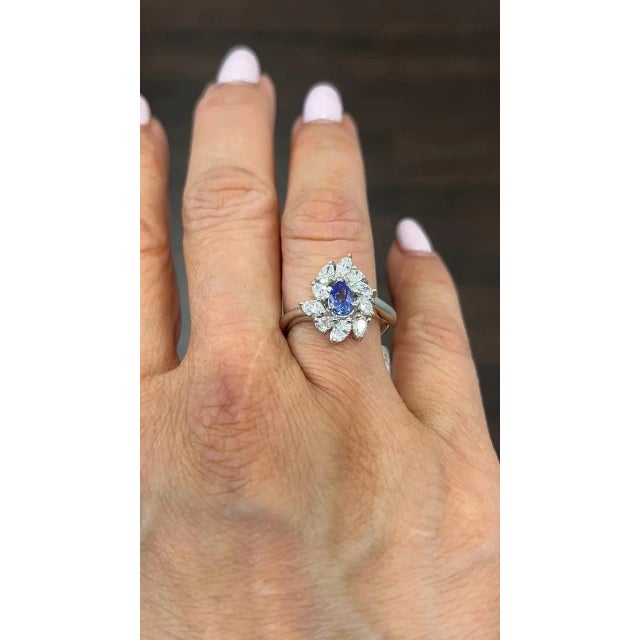 This exquisite ring features a stunning pear-shaped tanzanite stone complemented by sparkling diamonds. Set in platinum,...
