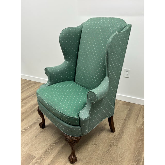 Elegant pair of Hickory Chair wingback lounge chairs featuring a classic Chippendale-inspired silhouette with beautifully...