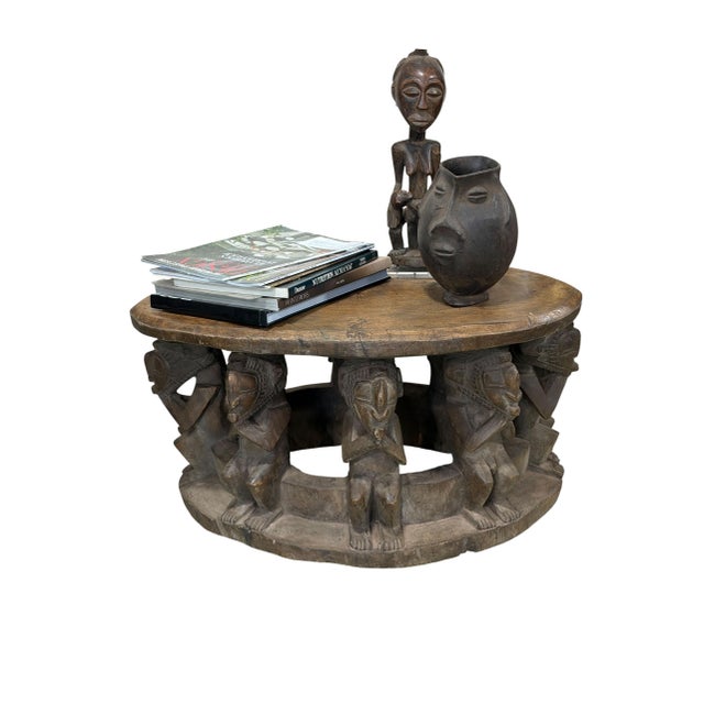 Exceptional vintage Baga carved stool, hand-crafted from a single piece of wood. Measuring 27.5" W × 15.5" D × 12" H, this...