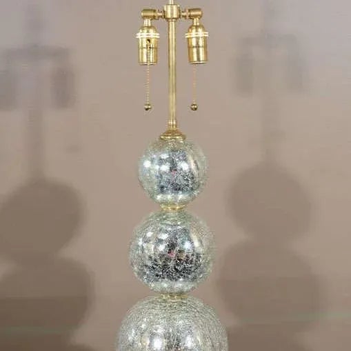 Pair of table lamps composed of stacked crackle finish mercury glass sphere. Made to order. Origin: United States...