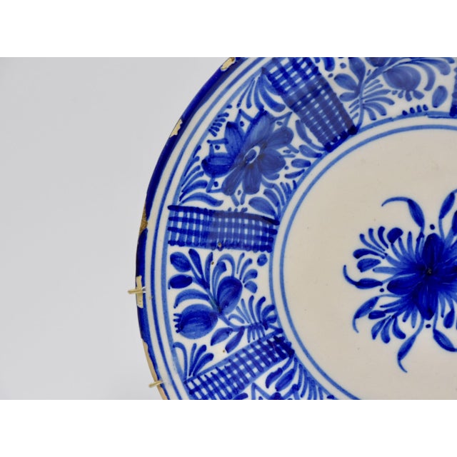 Antique Spanish cermaic plate from the 19th century form Manises, Spain. Blue and white hand painted decoration.